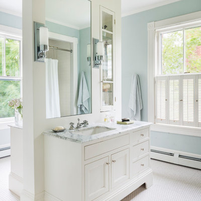 Inspiration for a large timeless master mosaic tile floor and white floor bathroom remodel in Boston with recessed-panel cabinets, white cabinets, blue walls, marble countertops and an undermount sink