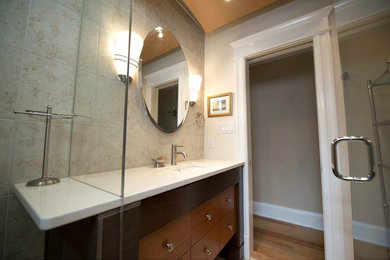 Inspiration for a medium sized contemporary ensuite bathroom in DC Metro with flat-panel cabinets, dark wood cabinets, beige walls, a submerged sink, quartz worktops, an alcove shower, beige tiles, stone tiles and medium hardwood flooring.