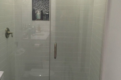 Inspiration for a mid-sized timeless 3/4 black tile, gray tile, white tile and porcelain tile porcelain tile and gray floor alcove shower remodel in San Diego with a two-piece toilet, white walls and a hinged shower door