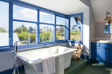 Eclectic master green floor freestanding bathtub photo in New York with shaker cabinets, blue cabinets and gray walls