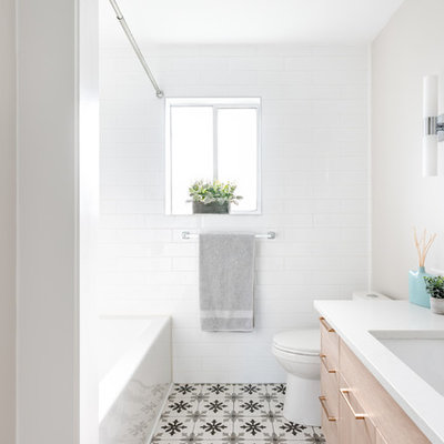 Transitional master porcelain tile and gray floor bathroom photo in Other with flat-panel cabinets, light wood cabinets, an undermount sink, quartz countertops and white countertops