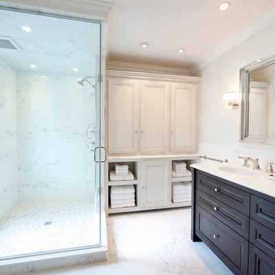 Inspiration for a mid-sized timeless master white tile and ceramic tile marble floor and white floor corner shower remodel in Philadelphia with an undermount sink, furniture-like cabinets, dark wood cabinets, a two-piece toilet, white walls, marble countertops and a hinged shower door
