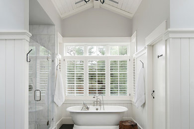 Example of a large cottage master white tile and marble tile marble floor and black floor bathroom design in San Francisco with gray walls and a hinged shower door