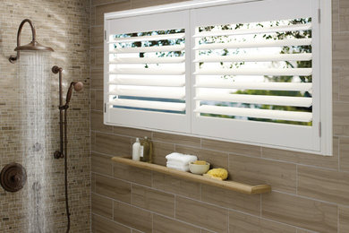 Example of a large trendy beige tile, brown tile and porcelain tile corner shower design in DC Metro