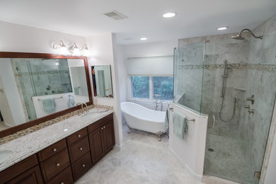 Design ideas for a large eclectic ensuite bathroom in DC Metro with a submerged sink, raised-panel cabinets, medium wood cabinets, granite worktops, a claw-foot bath, a corner shower, a two-piece toilet, grey tiles, stone tiles, white walls, marble flooring, white floors and a hinged door.