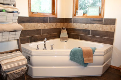 Example of a cottage corner bathtub design in Other