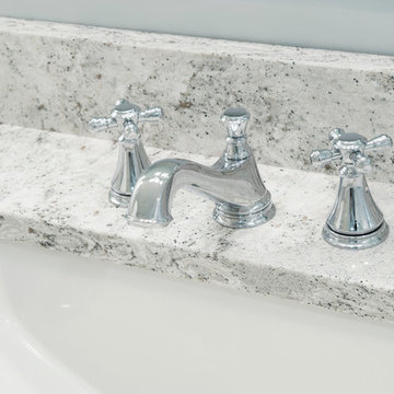 Polished chrome vanity faucet on Quartz countertop