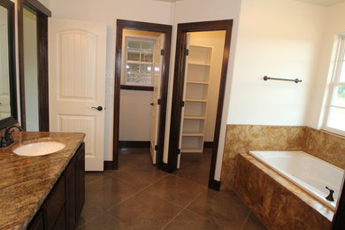 Example of a classic master concrete floor and brown floor bathroom design in Dallas with dark wood cabinets and concrete countertops