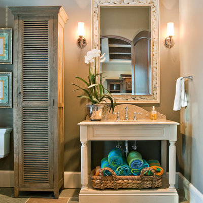 Elegant stone tile bathroom photo in Charleston with louvered cabinets, gray walls and light wood cabinets