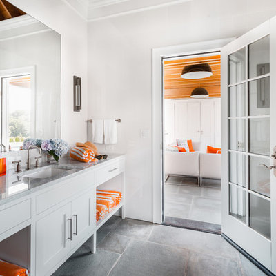 Bathroom - coastal gray floor bathroom idea in New York with shaker cabinets, white cabinets, white walls, an undermount sink, gray countertops and marble countertops