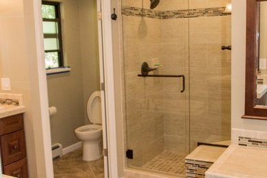 Inspiration for a mid-sized modern master ceramic tile bathroom remodel in Denver with raised-panel cabinets, medium tone wood cabinets, tile countertops and a one-piece toilet