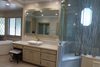 Inspiration for a large contemporary master gray tile and mosaic tile slate floor bathroom remodel in Los Angeles with raised-panel cabinets, beige cabinets, gray walls, a vessel sink and marble countertops