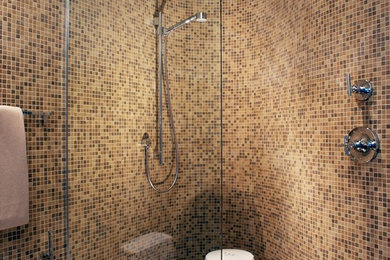 Design ideas for a medium sized contemporary ensuite bathroom in Denver with a built-in shower, a one-piece toilet, beige tiles, mosaic tiles, beige walls and mosaic tile flooring.