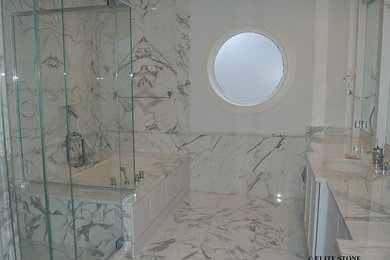 This is an example of a traditional bathroom in Chicago with a vessel sink, dark wood cabinets, marble worktops, a freestanding bath, a corner shower, white tiles, white walls and marble flooring.