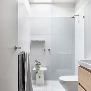 Contemporary bathroom in Melbourne with flat-panel cabinets, light wood cabinets, an alcove shower, gray tile, white walls, mosaic tile floors, a console sink, grey floor, an open shower, a single vanity and a floating vanity.