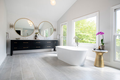 Transitional master white tile and subway tile gray floor freestanding bathtub photo in DC Metro with recessed-panel cabinets, black cabinets, gray walls, an undermount sink and white countertops