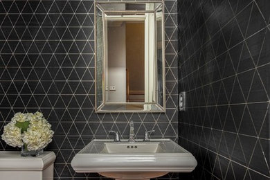 Bathroom - small contemporary 3/4 medium tone wood floor and brown floor bathroom idea in Charleston with a one-piece toilet, black walls and a pedestal sink