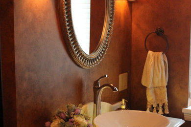 Bathroom - small traditional brown tile and porcelain tile bathroom idea in Minneapolis with a vessel sink, furniture-like cabinets, dark wood cabinets, onyx countertops and gray walls