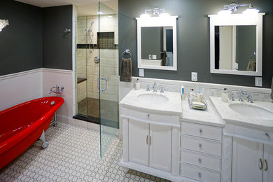 Large trendy master gray tile and marble tile ceramic tile and white floor bathroom photo in Columbus with recessed-panel cabinets, white cabinets, a one-piece toilet, gray walls, an undermount sink, marble countertops and a hinged shower door