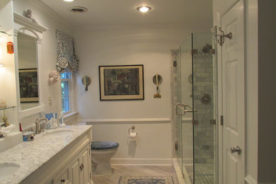 Example of a mid-sized classic master gray tile porcelain tile and gray floor bathroom design in Richmond with furniture-like cabinets, white cabinets, an undermount sink, marble countertops, a hinged shower door and white countertops