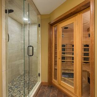 Example of a mid-sized transitional porcelain tile porcelain tile and brown floor corner shower design in Minneapolis with furniture-like cabinets, dark wood cabinets, beige walls, a drop-in sink and a hinged shower door