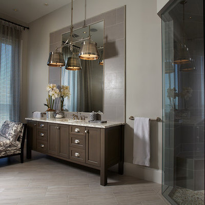 Inspiration for a tropical gray tile corner shower remodel in Miami with an undermount sink, shaker cabinets, dark wood cabinets and gray walls