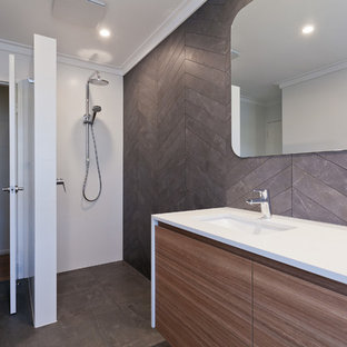Inspiration for a mid-sized contemporary master bathroom in Perth with flat-panel cabinets, medium wood cabinets, an open shower, a two-piece toilet, gray tile, porcelain tile, white walls, porcelain floors, an undermount sink, engineered quartz benchtops, grey floor, an open shower and white benchtops.