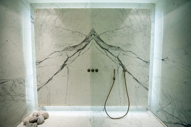 Photo of a bathroom in London with a walk-in shower, stone slabs and marble flooring.
