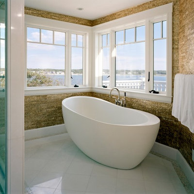 Trendy freestanding bathtub photo in Boston with brown walls