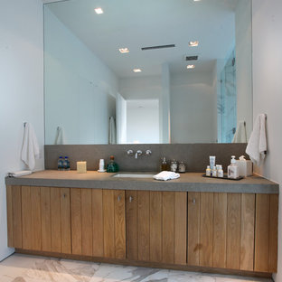 This is an example of a mid-sized modern 3/4 bathroom in Miami with medium wood cabinets, white tile, marble floors, flat-panel cabinets, stone tile, white walls, limestone benchtops, an undermount sink, grey floor and grey benchtops.