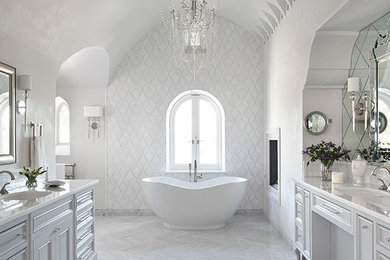 Inspiration for a mediterranean master white tile freestanding bathtub remodel in Austin with recessed-panel cabinets, white cabinets, white walls and an undermount sink