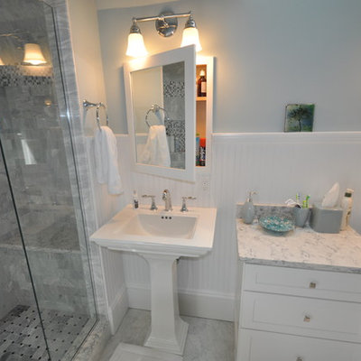 Alcove shower - mid-sized traditional 3/4 gray tile and stone tile marble floor alcove shower idea in Boston with shaker cabinets, white cabinets, a one-piece toilet, blue walls, a pedestal sink and quartzite countertops