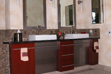 Bathroom - mid-sized transitional master brown tile and mosaic tile ceramic tile and gray floor bathroom idea in Other with flat-panel cabinets, red cabinets, beige walls, a vessel sink and quartz countertops