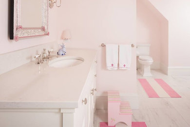 Inspiration for a mid-sized transitional kids' marble floor and white floor bathroom remodel in Minneapolis with recessed-panel cabinets, white cabinets, a two-piece toilet, white walls, an undermount sink, marble countertops and white countertops