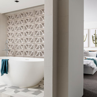 Inspiration for a contemporary master bathroom in Sydney with a freestanding tub, multi-coloured floor and grey benchtops.