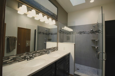 Example of a mid-sized transitional master beige tile and porcelain tile porcelain tile doorless shower design in Other with recessed-panel cabinets, dark wood cabinets and quartzite countertops