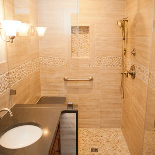 Inspiration for a mid-sized traditional 3/4 bathroom in New York with recessed-panel cabinets, dark wood cabinets, an alcove shower, a one-piece toilet, beige tile, porcelain tile, beige walls, porcelain floors, an undermount sink and zinc benchtops.