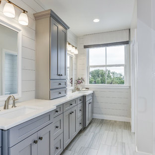 Example of a country gray floor bathroom design in DC Metro with shaker cabinets, gray cabinets, gray walls, an undermount sink, a hinged shower door and white countertops