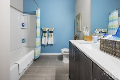 Inspiration for a mid-sized ceramic tile bathroom remodel in Seattle with flat-panel cabinets, gray cabinets, blue walls, an undermount sink and quartzite countertops