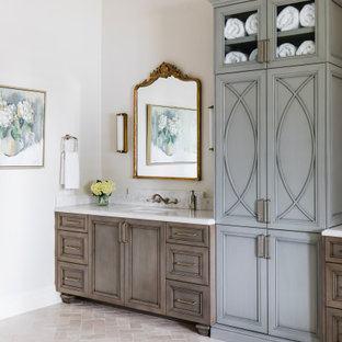 Example of a tuscan limestone floor, double-sink and coffered ceiling bathroom design in Phoenix with recessed-panel cabinets, blue cabinets, marble countertops, a hinged shower door and a built-in vanity