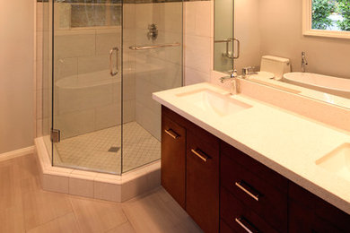 Medium sized traditional ensuite bathroom in Los Angeles with a submerged sink, flat-panel cabinets, dark wood cabinets, engineered stone worktops, a freestanding bath, a corner shower, a one-piece toilet, grey tiles, porcelain tiles and porcelain flooring.