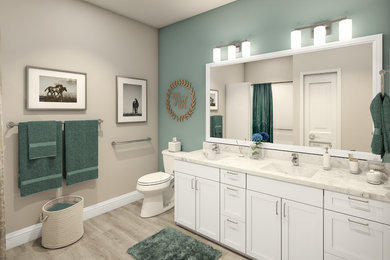 Example of a mid-sized transitional master laminate floor and gray floor bathroom design in Kansas City with recessed-panel cabinets, white cabinets, a one-piece toilet, green walls, an integrated sink, granite countertops and white countertops