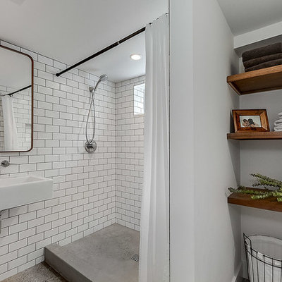Bathroom - small industrial 3/4 white tile and subway tile concrete floor and brown floor bathroom idea in Seattle with white walls and a wall-mount sink