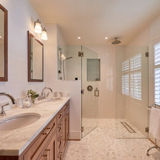 Inspiration for a mid-sized transitional master bathroom in Seattle with shaker cabinets, medium wood cabinets, a curbless shower, a two-piece toilet, white tile, porcelain tile, blue walls, marble floors, an undermount sink, marble benchtops, white floor, a hinged shower door, multi-coloured benchtops, a shower seat, a double vanity and a built-in vanity.