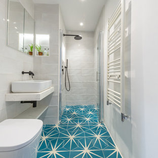 Mediterranean shower room bathroom in London with an alcove shower, white tiles, white walls, cement flooring, a vessel sink, blue floors, a hinged door and white worktops.