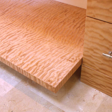 quilted maple custom shelf, brushed chrome cabinet pulls, limestone tile