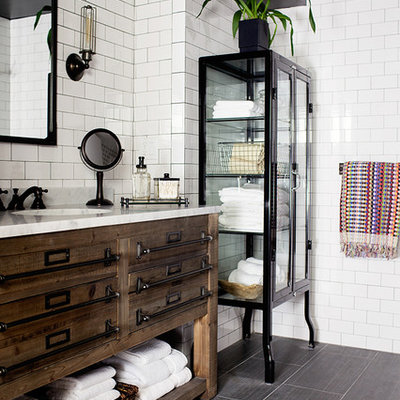 Transitional white tile and subway tile ceramic tile bathroom photo in New York with an undermount sink, marble countertops, black walls and flat-panel cabinets