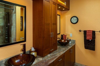 Bathroom - modern 3/4 ceramic tile bathroom idea in Orange County with flat-panel cabinets, medium tone wood cabinets, yellow walls, a vessel sink and granite countertops