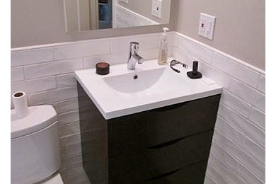 Inspiration for a mid-sized contemporary master white tile and porcelain tile ceramic tile bathroom remodel in San Francisco with flat-panel cabinets, dark wood cabinets, quartz countertops, a one-piece toilet, beige walls and an integrated sink