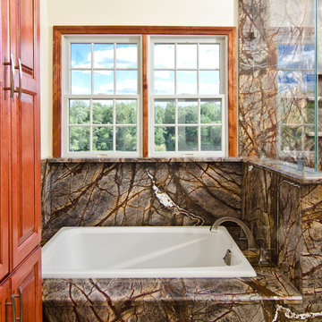 Rainforest Brown Granite vanity, tub surround, and shower wall